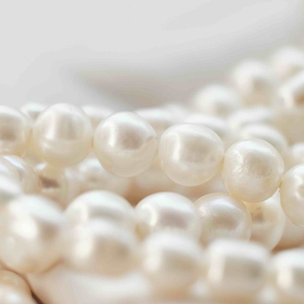 Strands of cultured white pearls